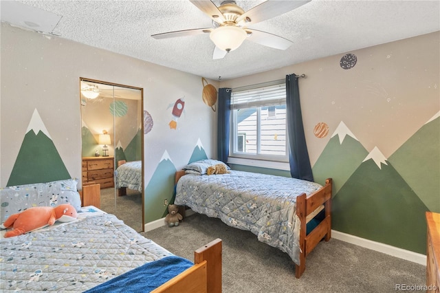 bedroom with dark colored carpet, ceiling fan, and a textured ceiling