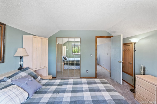 bedroom featuring lofted ceiling, carpet floors, a textured ceiling, and ensuite bathroom