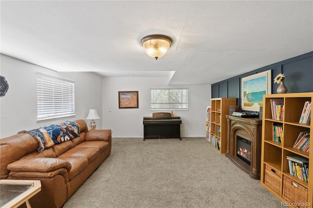 living room with a textured ceiling and carpet