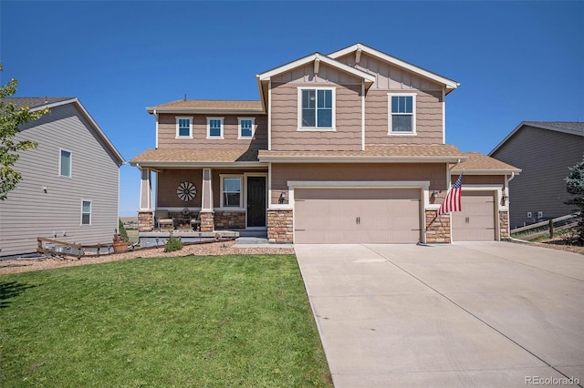 craftsman house with a front yard and a garage