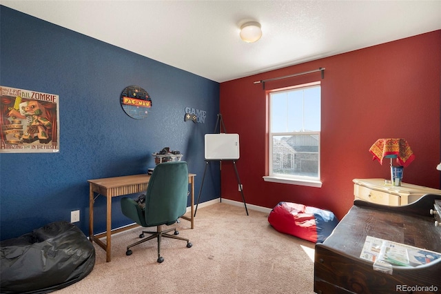 office with a textured wall, baseboards, and carpet floors