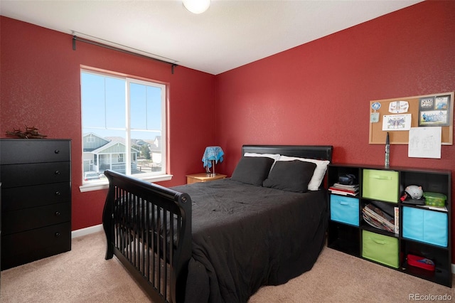 bedroom featuring light colored carpet