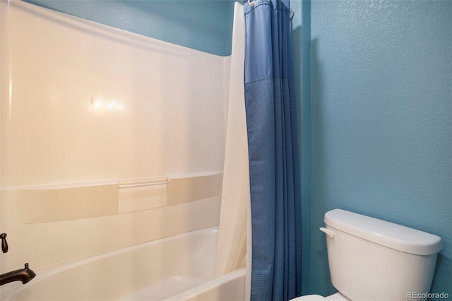 bathroom with toilet and shower / tub combo