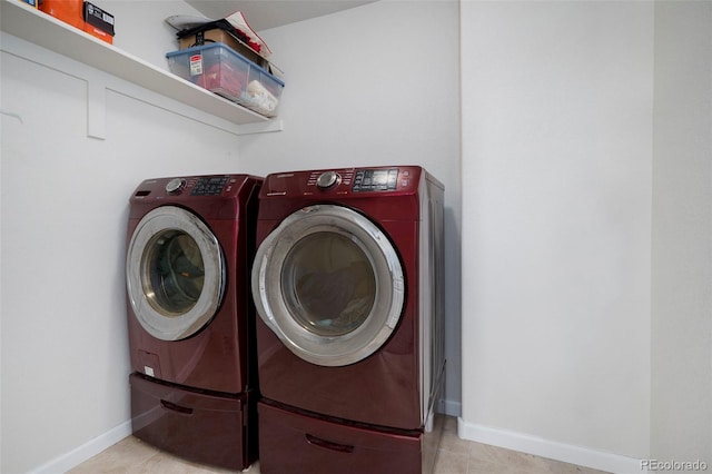 clothes washing area featuring washer and dryer, laundry area, and baseboards