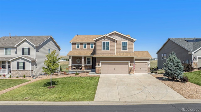 craftsman-style house featuring board and batten siding, a front yard, a garage, stone siding, and driveway