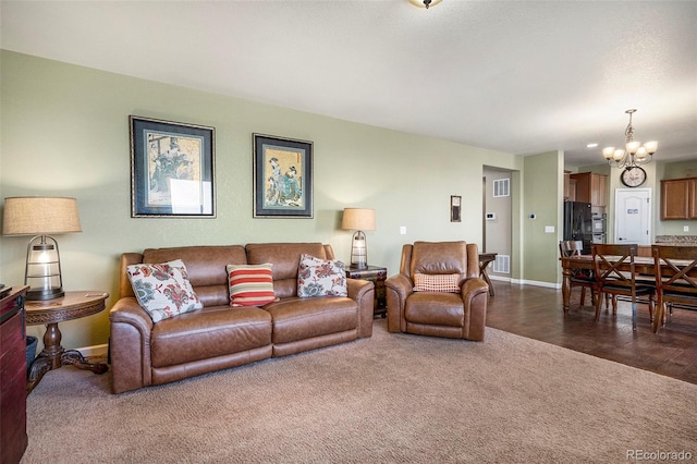 living area with a notable chandelier, baseboards, visible vents, and dark carpet