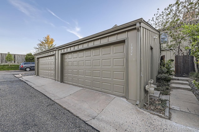 detached garage featuring fence