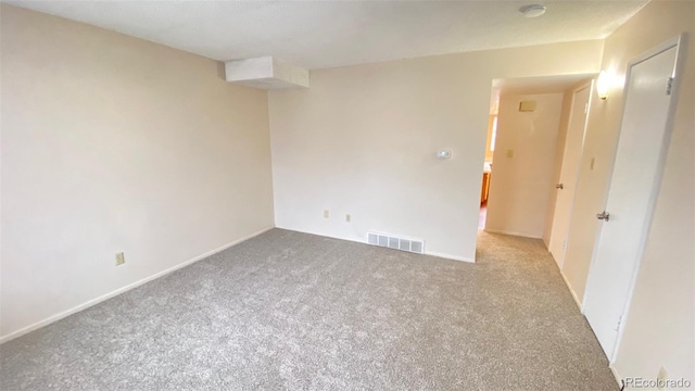 carpeted spare room with visible vents