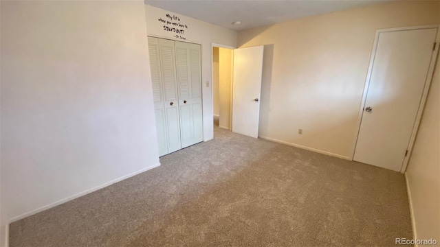 unfurnished bedroom featuring carpet, a closet, and baseboards