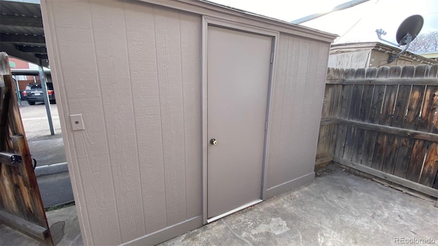 view of shed featuring fence