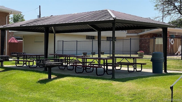 view of community with a yard and fence