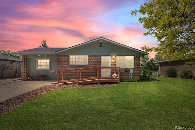 view of front facade with brick siding and a wooden deck
