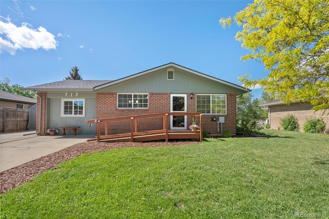 back of house featuring brick siding and a wooden deck
