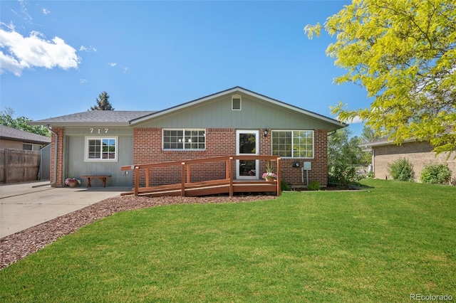 back of property featuring brick siding and a deck