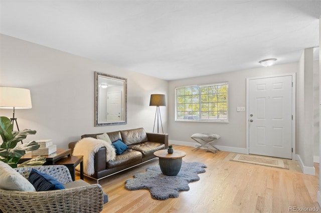living room featuring baseboards and wood finished floors