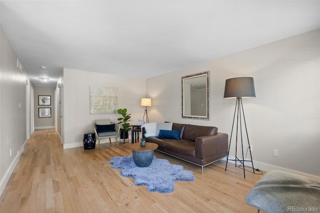 living room featuring wood finished floors and baseboards