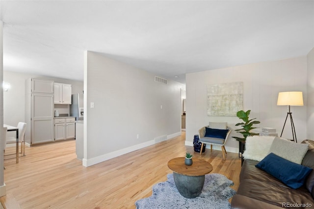 living room featuring light wood-style floors and baseboards