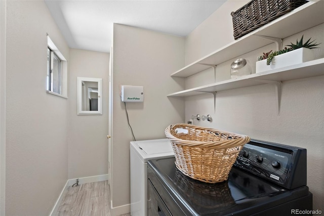 washroom featuring separate washer and dryer, baseboards, and light wood-style floors