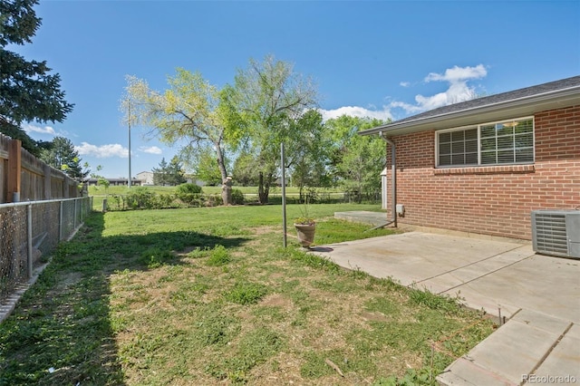 view of yard with central AC and a patio area