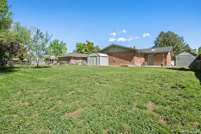 view of yard featuring a storage unit and an outbuilding