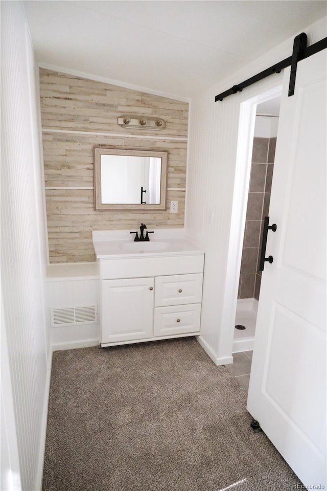 bathroom featuring visible vents, vanity, and a stall shower
