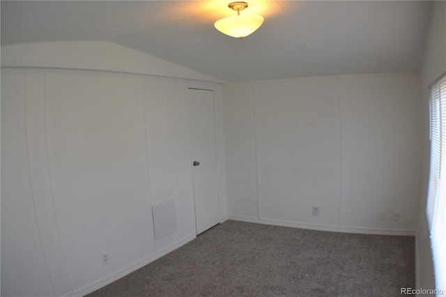 empty room with lofted ceiling and carpet