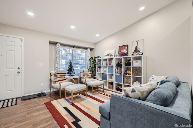 living area with hardwood / wood-style floors and lofted ceiling