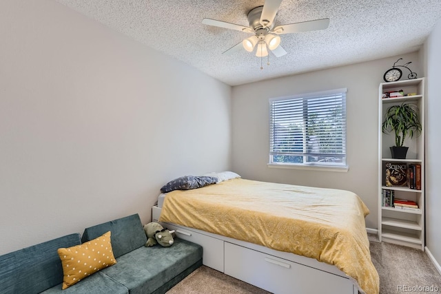 carpeted bedroom featuring a textured ceiling and ceiling fan