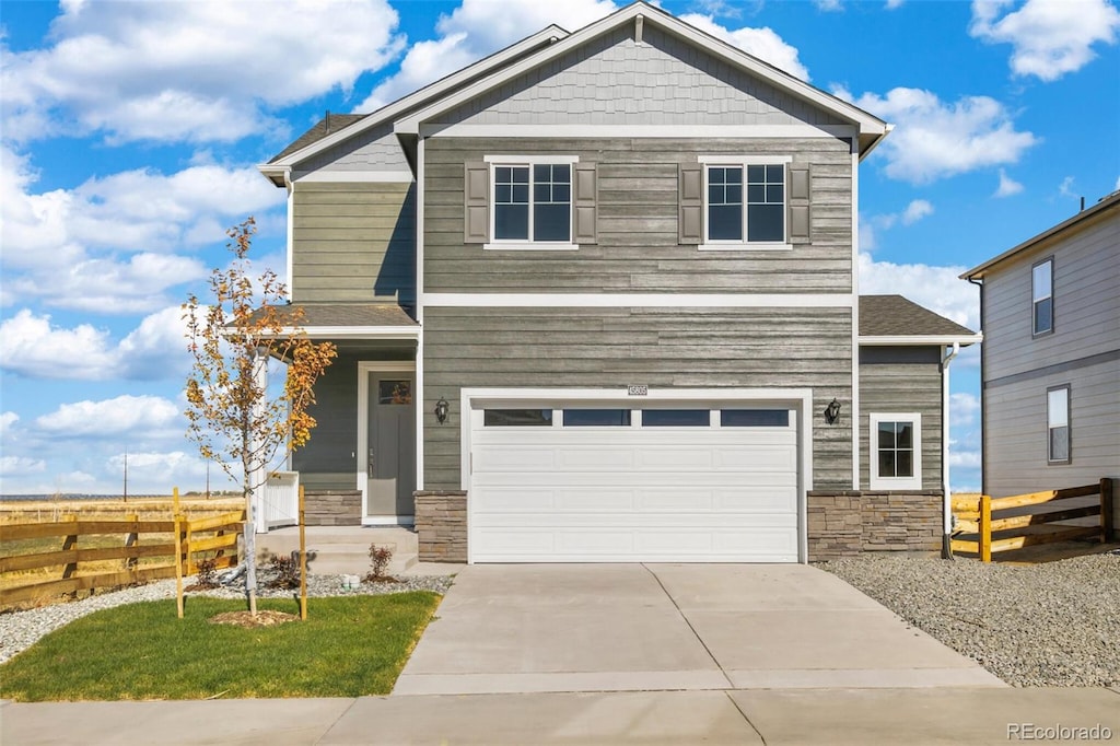 17949 Dandy Brush Ln, Parker, CO 80134 - craftsman-style home with stone siding, fence, driveway, and a garage