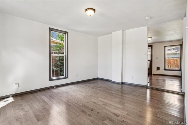 646 Maple St, Colorado Springs, CO 80903 - empty room with wood finished floors and a smoke detector