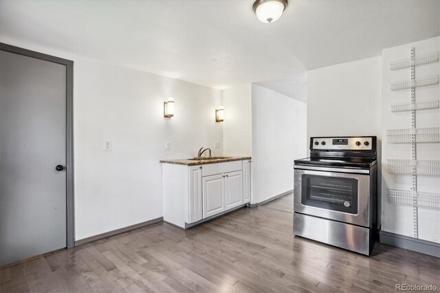 646 Maple St, Colorado Springs, CO 80903 - kitchen featuring stainless steel electric range, wood finished floors, stone counters, and white cabinets