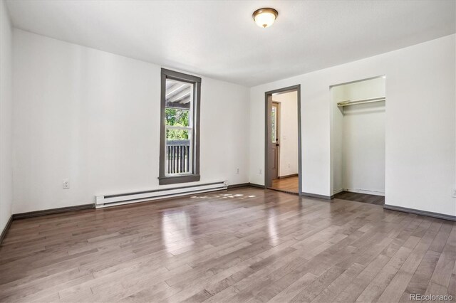646 Maple St, Colorado Springs, CO 80903 - unfurnished bedroom with a baseboard radiator, wood finished floors, and a closet