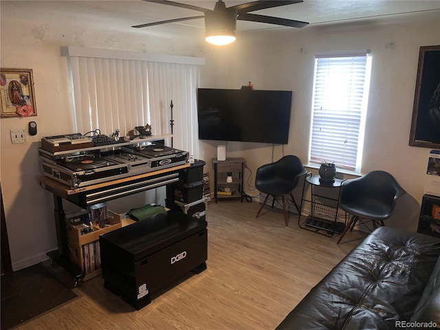 living room with ceiling fan and light hardwood / wood-style floors