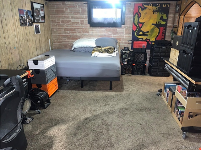 bedroom with brick wall, carpet, and wooden walls