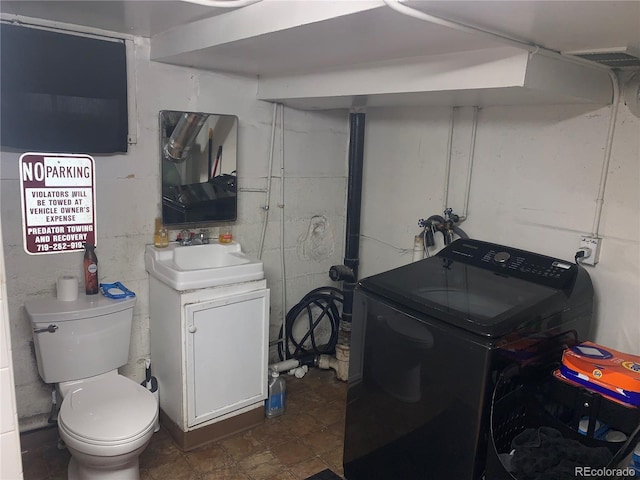 interior space featuring washer / dryer, toilet, and vanity