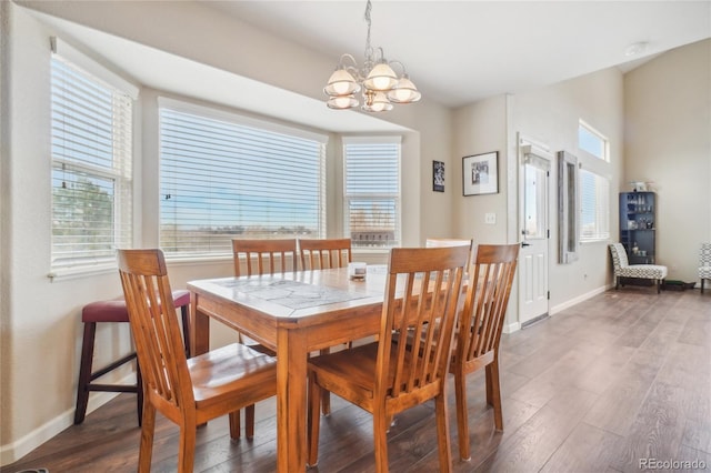 dining space featuring a chandelier and dark wood-type flooring