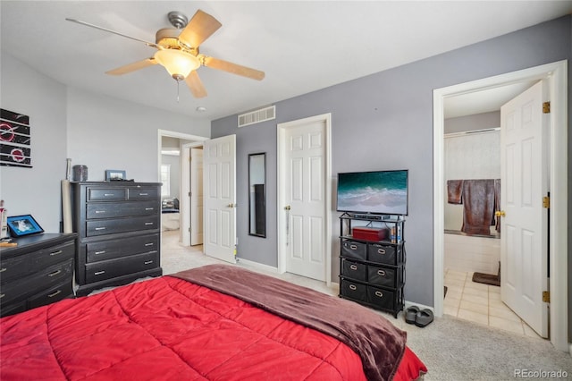 carpeted bedroom with connected bathroom and ceiling fan