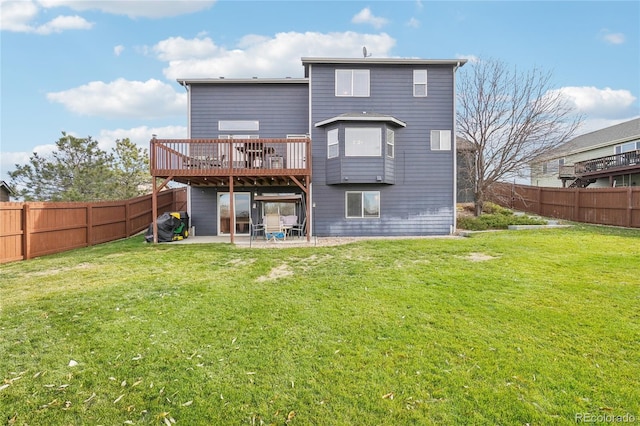 back of house featuring a lawn, a patio area, and a deck