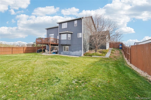 back of property featuring a wooden deck and a lawn