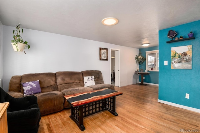 living room featuring light wood-type flooring and baseboards