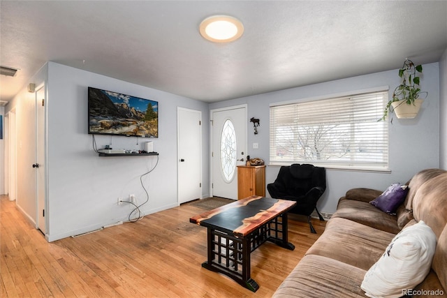 living area featuring light wood-type flooring and baseboards