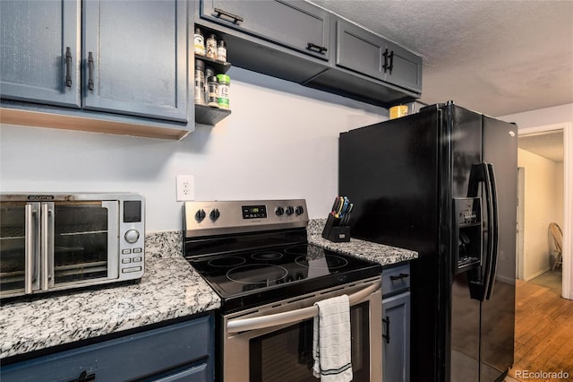 kitchen featuring a toaster, black fridge with ice dispenser, electric range, a textured ceiling, and wood finished floors