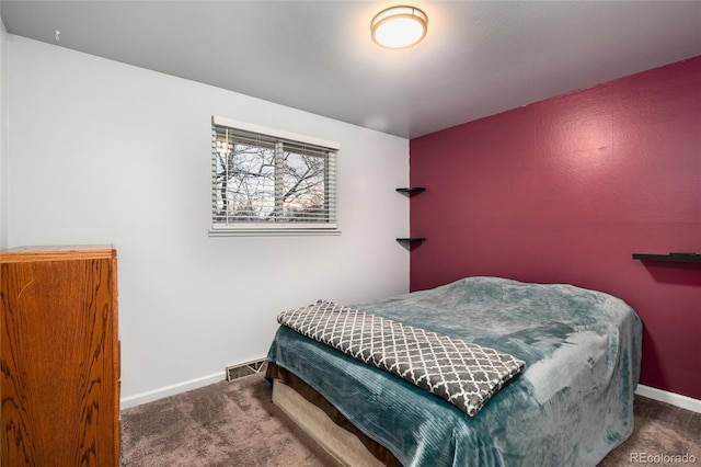 carpeted bedroom with baseboards and visible vents