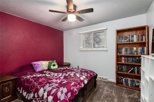 carpeted bedroom featuring a ceiling fan and visible vents