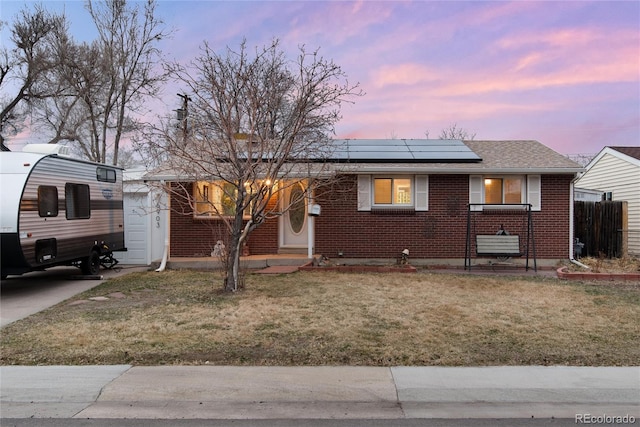 6903 W 52nd Pl, Arvada, CO 80002 - view of front facade with brick siding and roof mounted solar panels