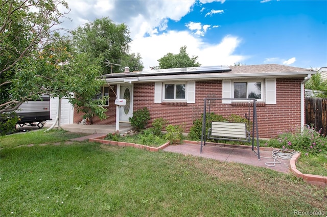 6903 W 52nd Pl, Arvada, CO 80002 - view of front of house featuring solar panels, brick siding, and a patio