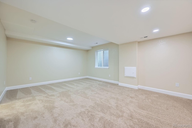 unfurnished room featuring recessed lighting, light carpet, visible vents, and baseboards