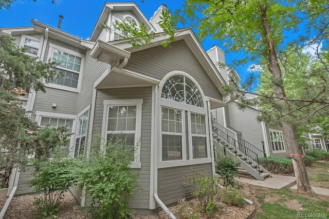 6711 S Ivy Way Unit A2, Centennial, CO 80112 - view of side of property with a chimney and stairs
