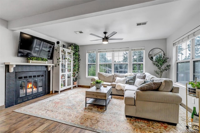 6711 S Ivy Way Unit A2, Centennial, CO 80112 - living area with wood finished floors, ceiling fan, and a tile fireplace