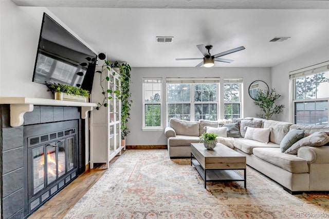 6711 S Ivy Way Unit A2, Centennial, CO 80112 - living room featuring a glass covered fireplace, wood finished floors, and a ceiling fan